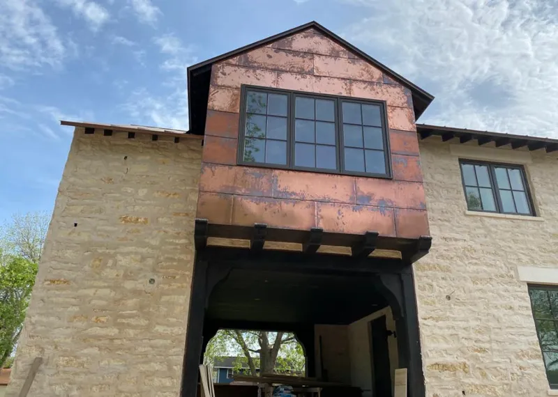 Copper metal panel facade on a stone building for Metal Roof Coating in Basehor
