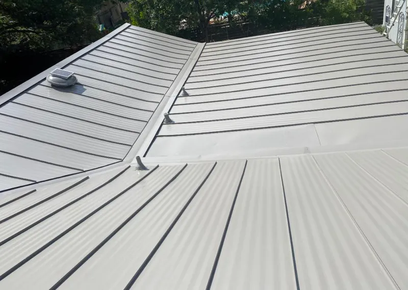 Solar attic fan installed on a metal roof for Roof Ventilation in Basehor